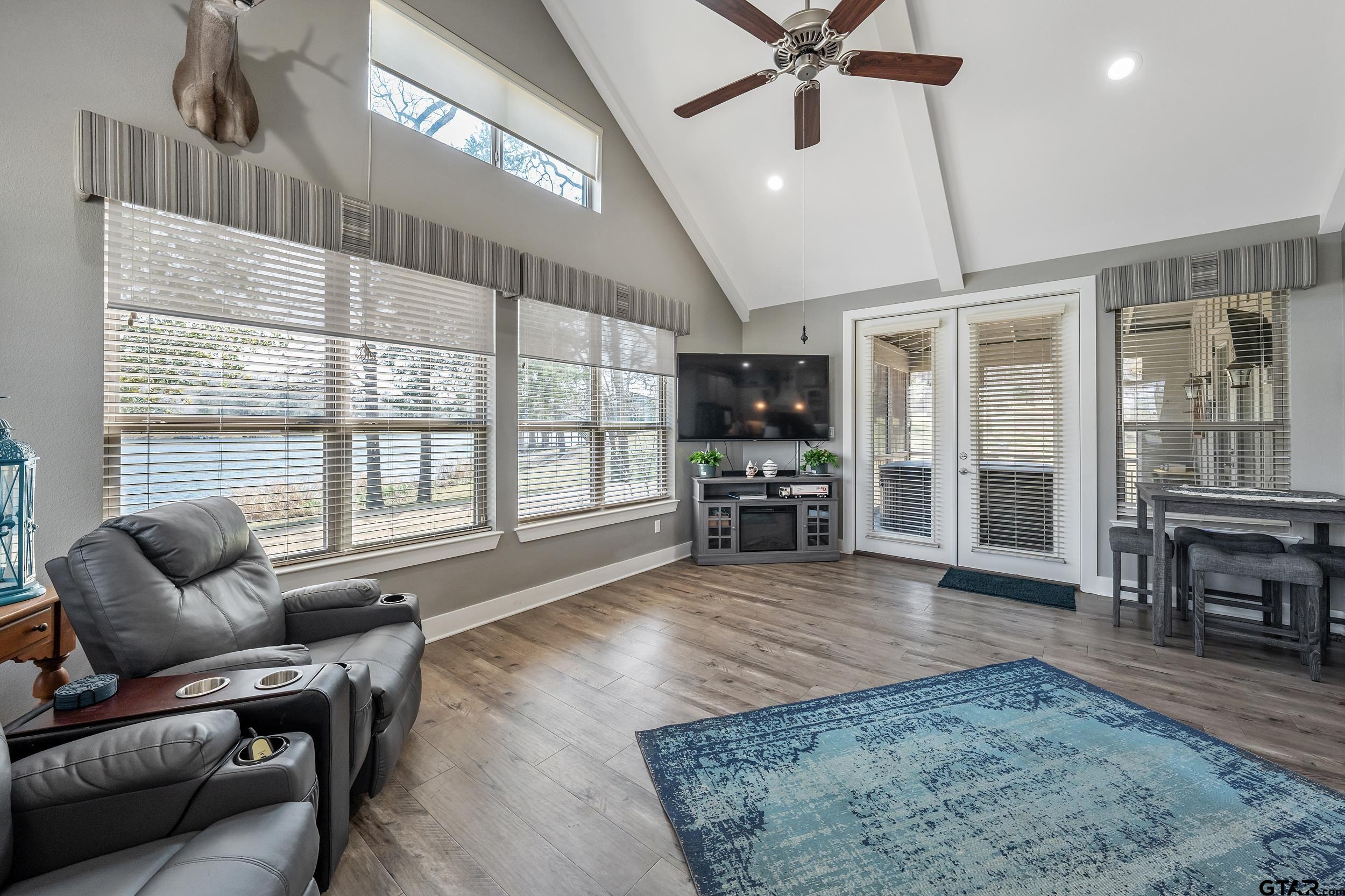 10918 Spring Club Lake Tyler, TX 75706 - Photo 10 of 23 a living room with furniture and a flat screen tv