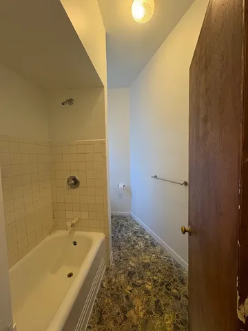 a bathroom with a bathtub and shower