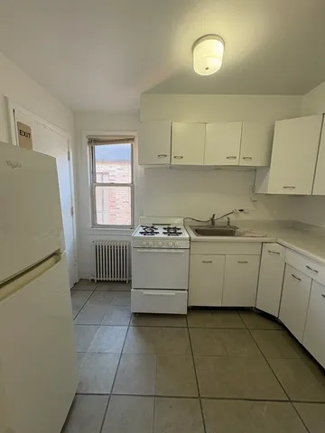 a kitchen with a cabinets and white appliances