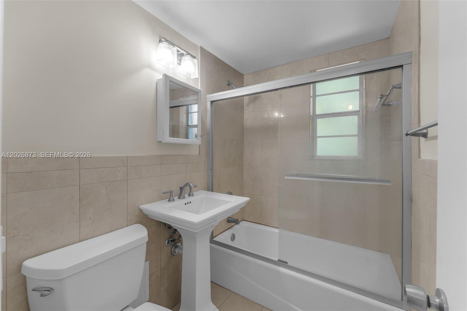 5590 Southwest 78th Street, Unit 133B Miami, FL 33143 - Photo 10 of 18 a bathroom with a sink toilet and shower