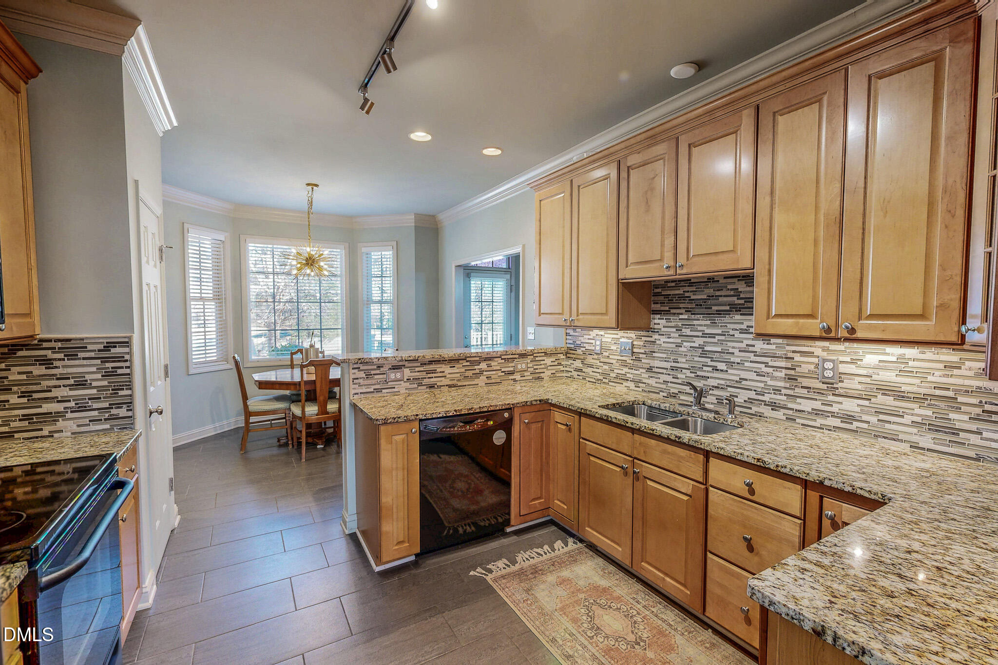189 Hannah Lane Roxboro, NC 27574 - Photo 14 of 37 a kitchen with stainless steel appliances granite countertop a stove top oven a sink dishwasher a dining table and chairs with wooden floor