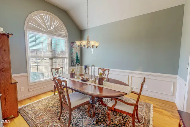a view of a dining room with furniture and a chandelier