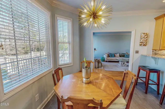 a view of a dining room with furniture and a potted plant