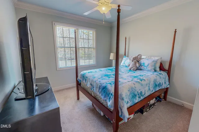 a large bed sitting in a bedroom next to a window