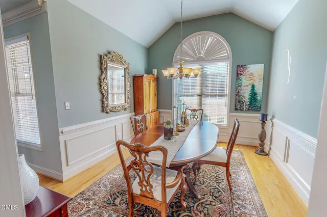 a view of a dining room with furniture and a chandelier