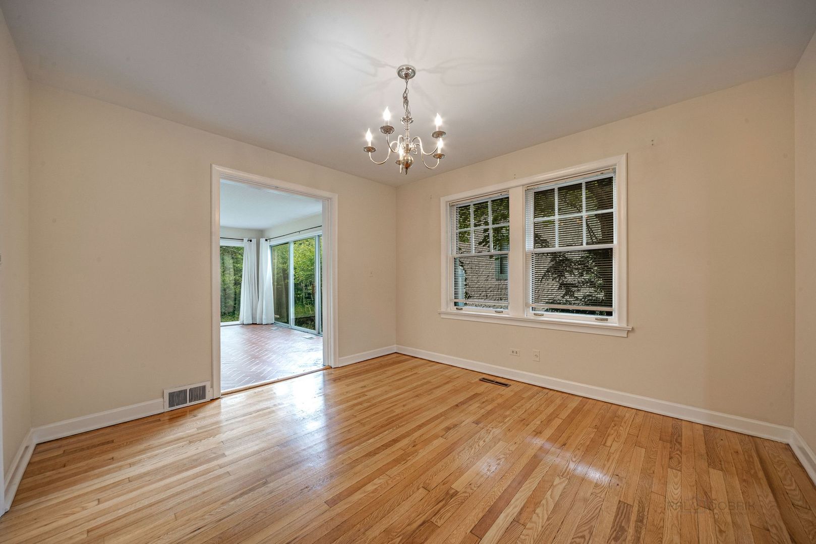 175 Wildwood Road Lake Forest, IL 60045 - Photo 6 of 28 a view of an empty room with wooden floor and a window