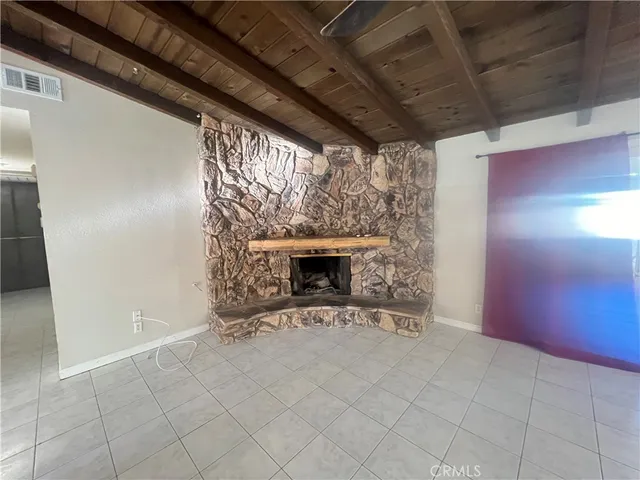 a view of an empty room with a fireplace