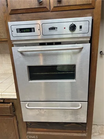 a stove top oven sitting inside of a kitchen