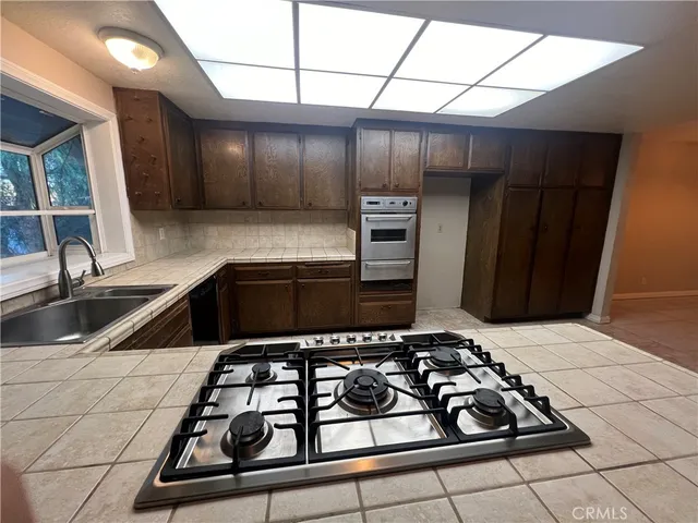 a kitchen with a sink a stove and a refrigerator