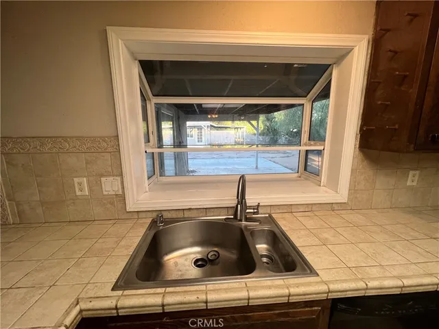 a kitchen with a sink and wooden cabinets