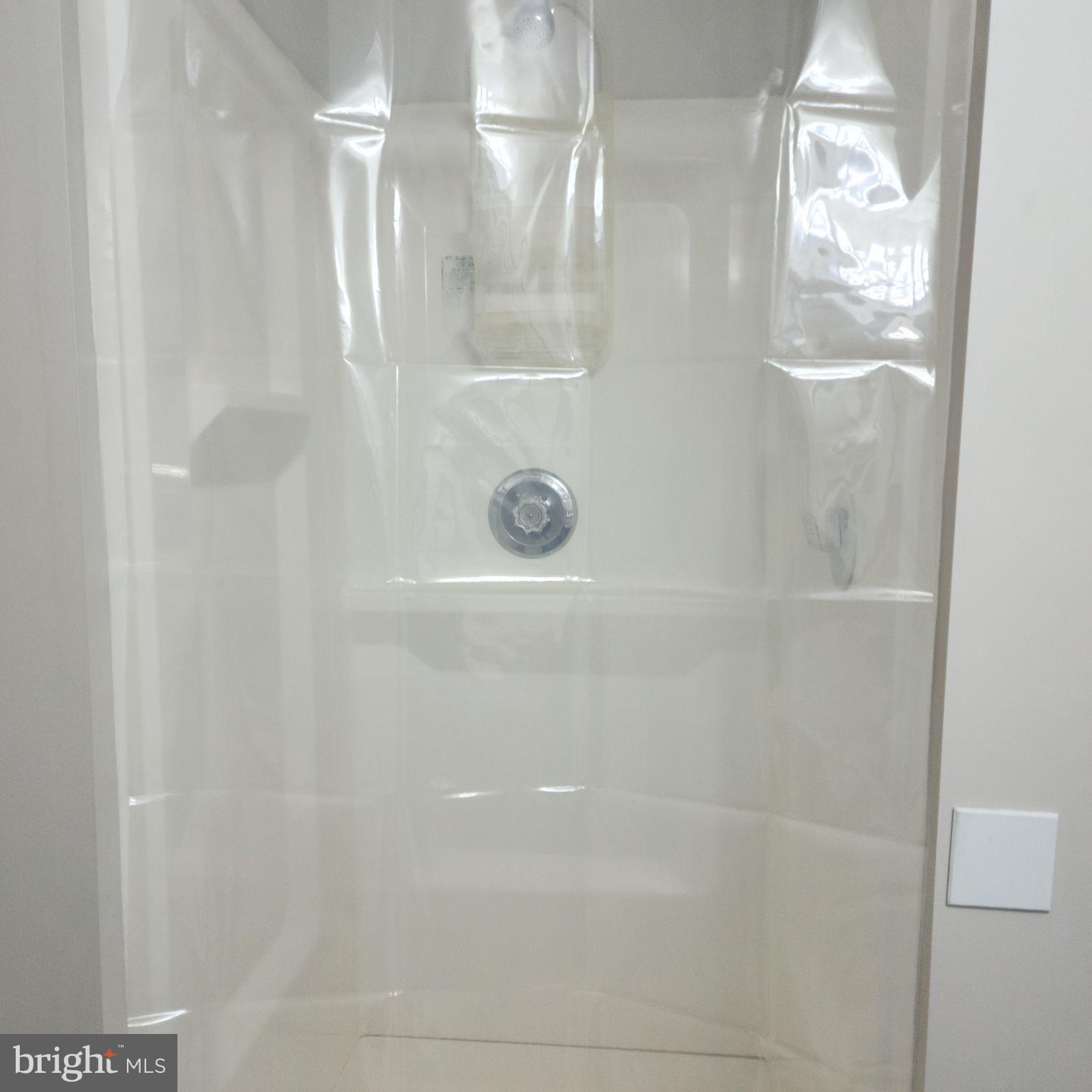 9016 O'Keith Court Springfield, VA 22152 - Photo 4 of 13 a bathroom with a glass shower door