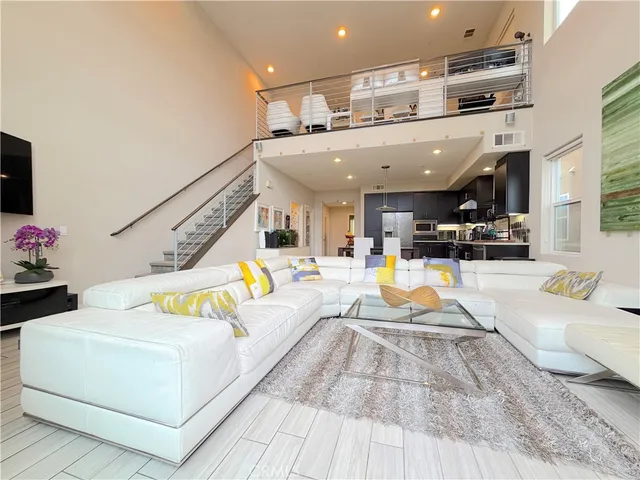 a living room with furniture and kitchen view