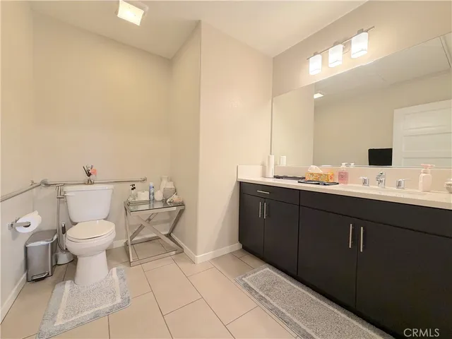 a bathroom with a sink toilet and mirror
