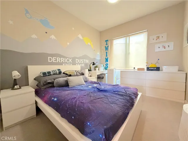 a spacious bedroom with a bed furniture and a ceiling fan