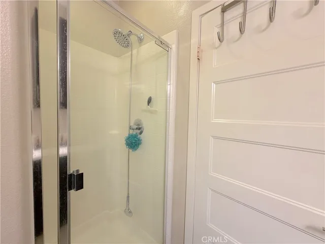 a view of a bedroom with a furniture and a ceiling fan