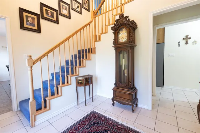 a spacious bedroom with a bed and a chandelier