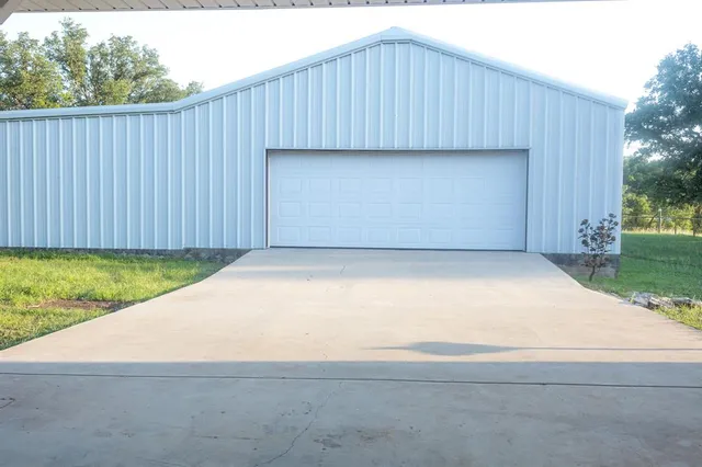 a view of backyard of house with green space
