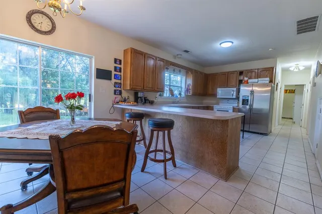 a kitchen with stainless steel appliances granite countertop a stove a sink dishwasher and a refrigerator
