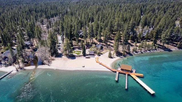 a park view with a table and chairs with wooden fence