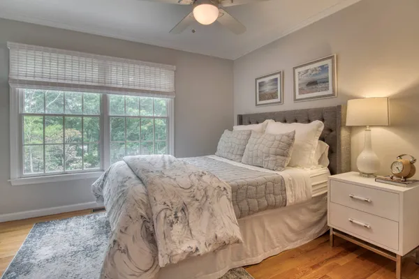 a bedroom with a bed and a window