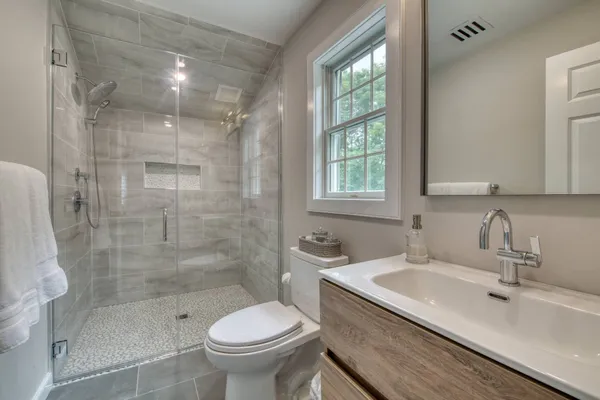 a bathroom with a sink toilet and shower