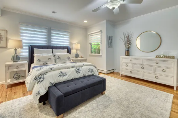 a bed room with a bed mirror and a window