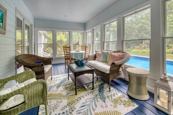 a living room with furniture and a floor to ceiling window