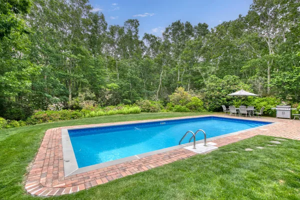 a view of yard with swimming pool and green space