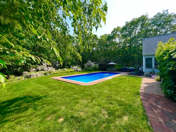 a view of yard with swimming pool and yard