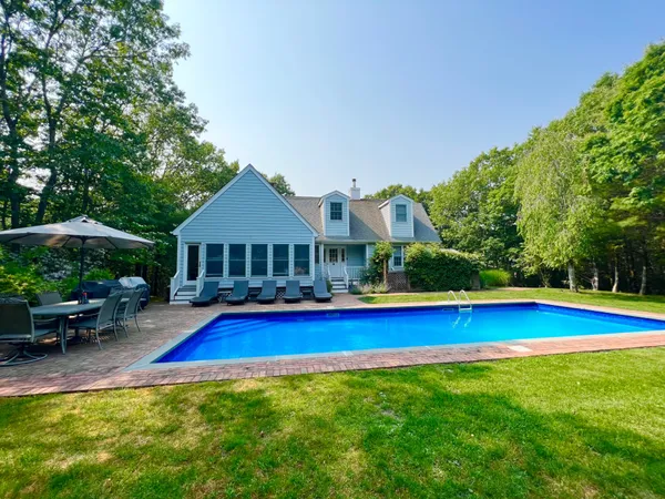 a view of pool outdoor seating and yard