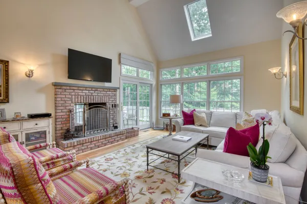 a living room with furniture fireplace and a flat screen tv