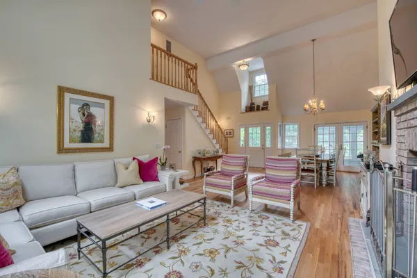 a living room with furniture a rug and a chandelier