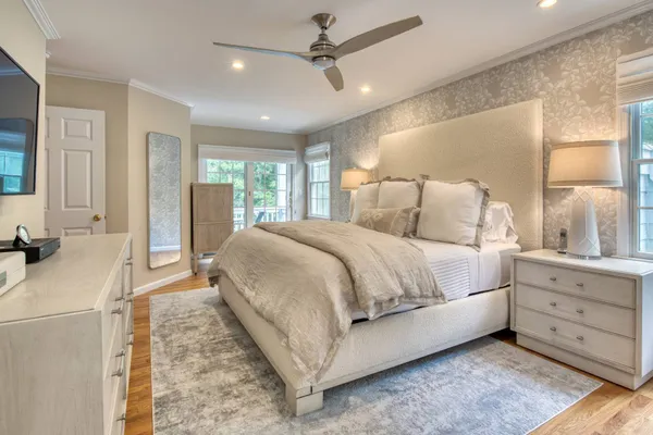 a spacious bedroom with a large bed and a dresser