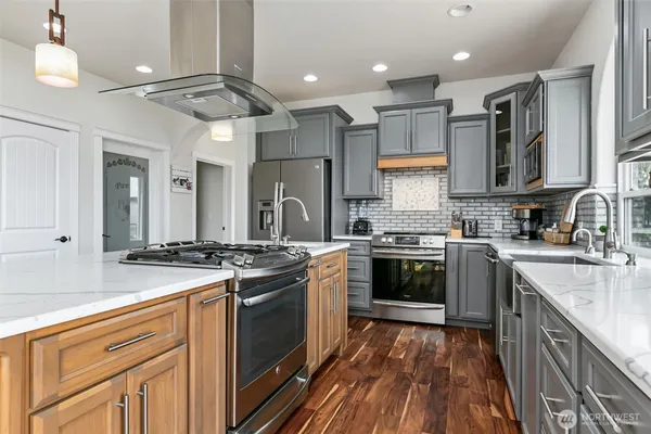 a kitchen with stainless steel appliances granite countertop a stove and a sink