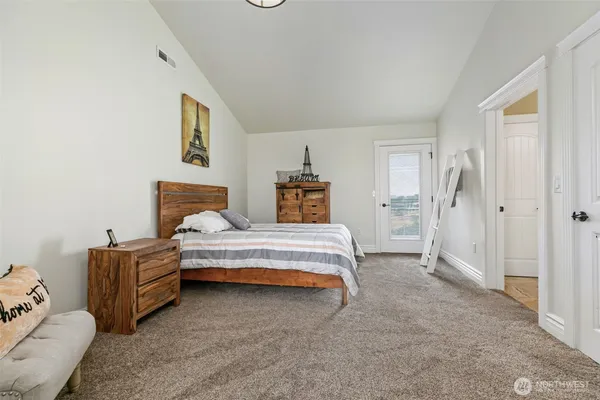 a spacious bedroom with a bed and a couch