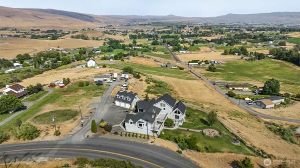an aerial view of residential houses with outdoor space
