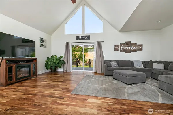 a living room with furniture a flat screen tv and a fireplace