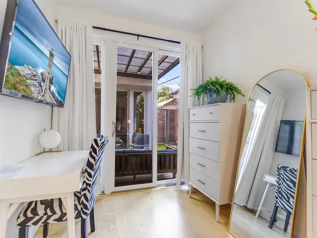 a view of an entryway with furniture and wooden floor