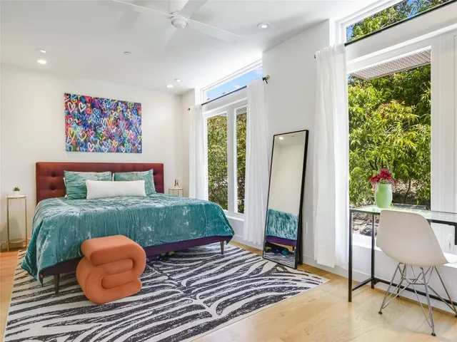 a bedroom with a bed and a window