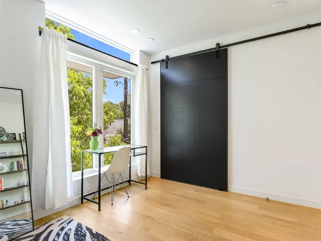 a view of an empty room and a window