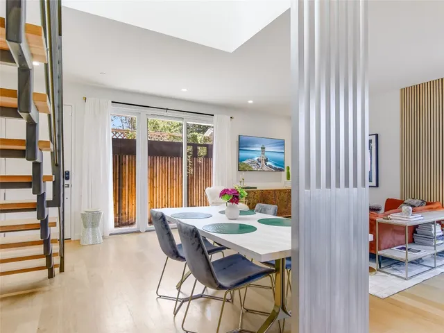 a view of a dining room with furniture and a potted plant