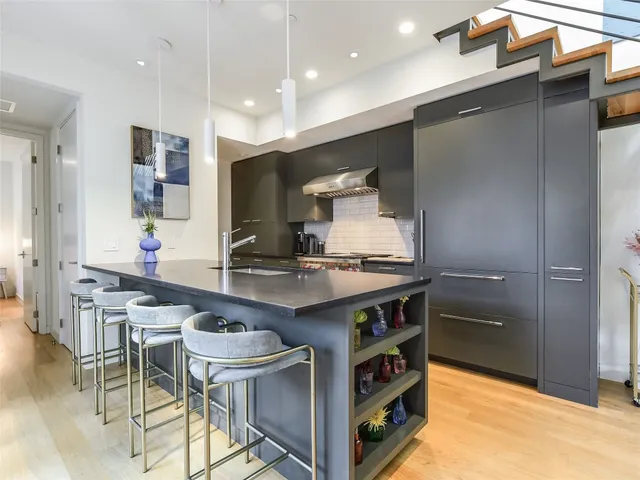 a kitchen with stainless steel appliances granite countertop a stove and a refrigerator