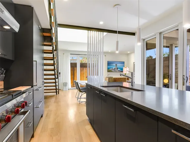 a kitchen with counter top space and wooden floor