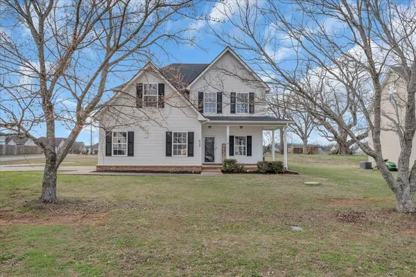a front view of a house with a yard