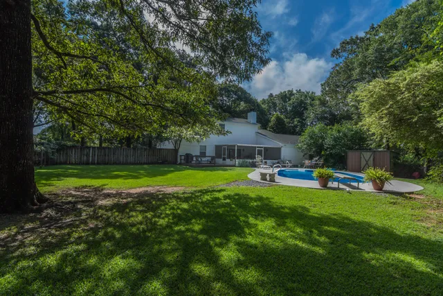 a view of a backyard with swimming pool