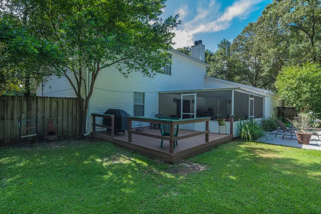 a view of backyard with swimming pool and seating space