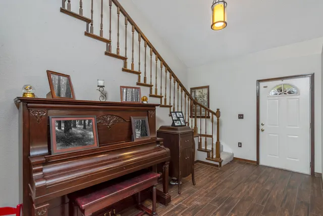 a living room with furniture and a chandelier