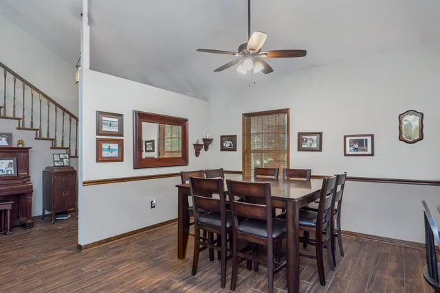 a kitchen with stainless steel appliances granite countertop a kitchen island a table and chairs