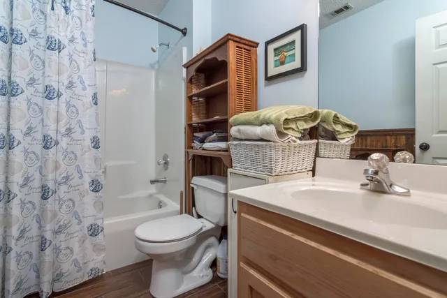 a bedroom with a bed and a mirror on dresser