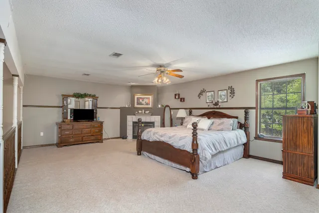 a spacious bedroom with a bed and a large window